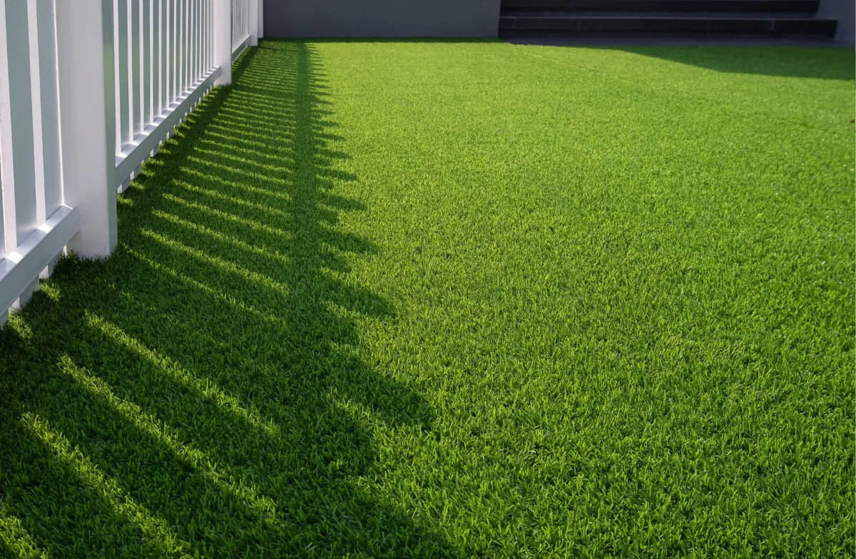 Level artificial grass lawn draining freely along a Vaughan fence line